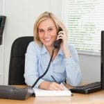 Image of a businesswoman using proper business phone etiquette