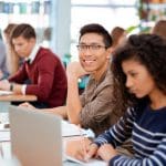 Image of a group of students studying in a library who have benefited from a university call center