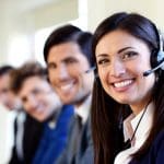 Image of four people in a call center answering phones for a business that understands the benefits of outsourcing