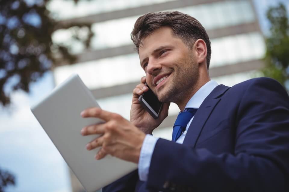Image of a businessman using Signius Interactive Voice Response on his cell phone