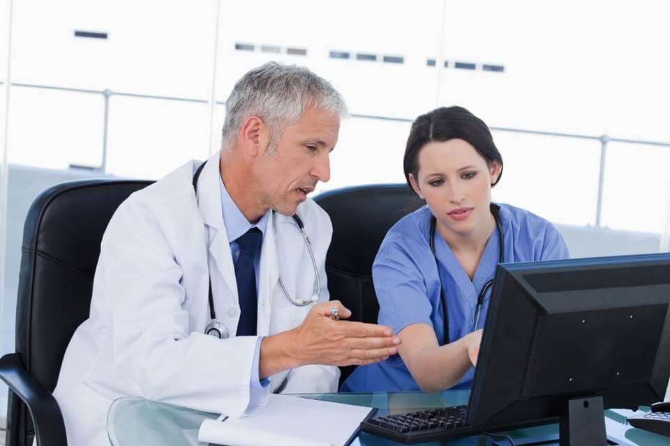 Image of two healthcare professionals using a secure messaging system