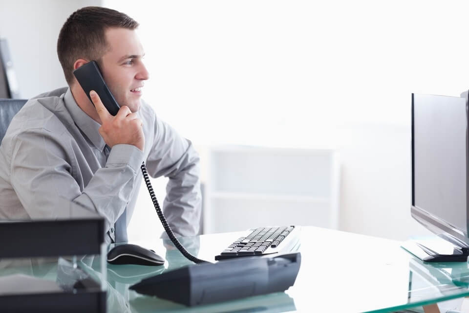 Image of a businessman using Signius voicemail solutions in his office