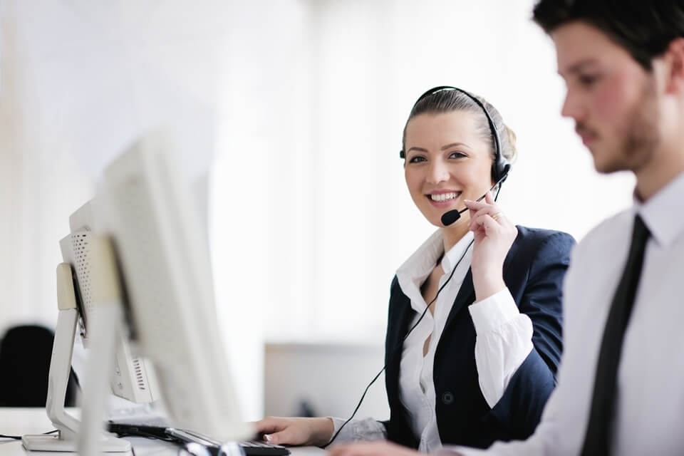 Image of two Signius call center employees providing whistleblower hotline services