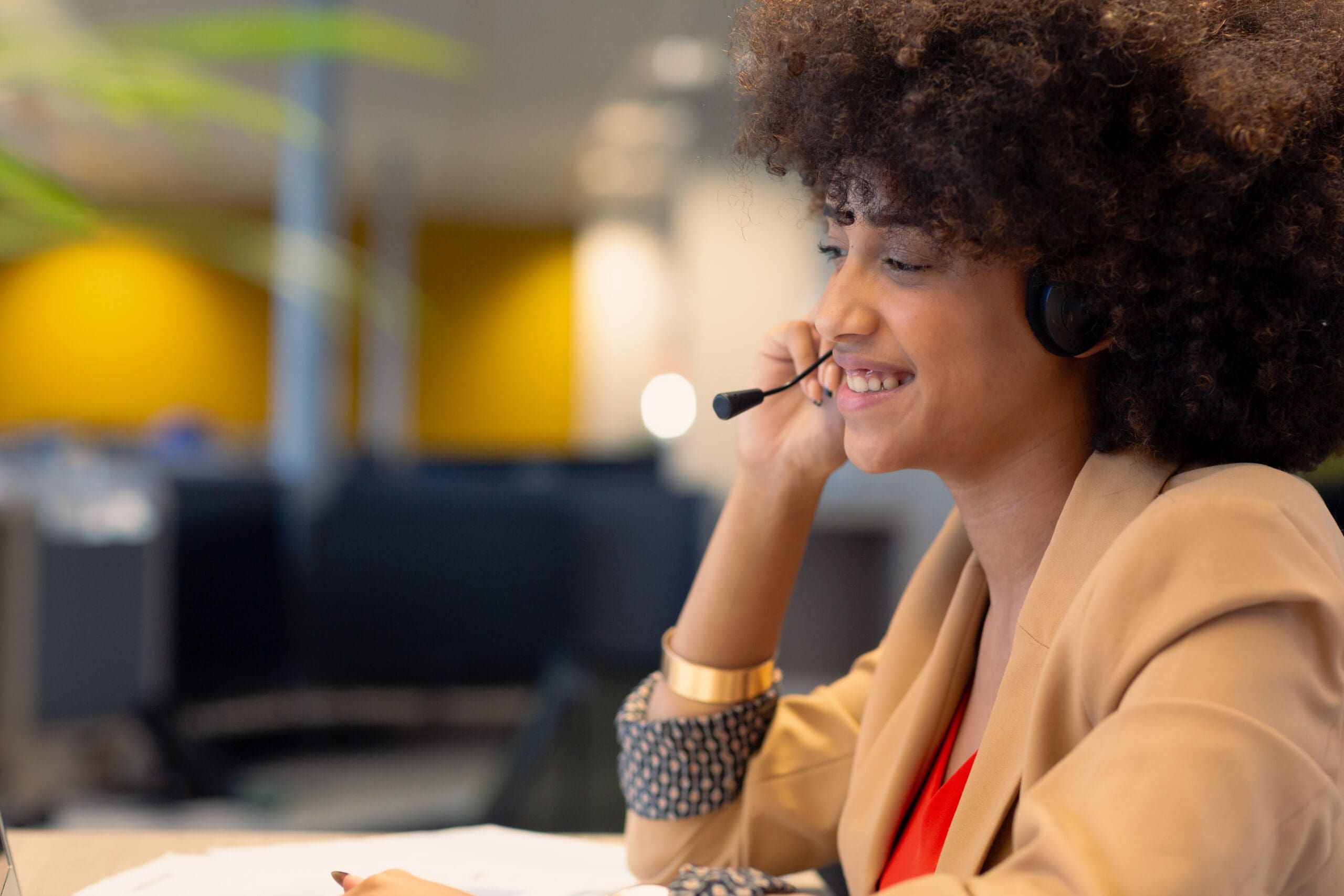 Smiling Young African American Female Telecaller Talking Through Headset At Workplace. Unaltered, Business, Modern Office And Technology Concept.